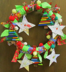 Collaborative holiday wreath made by students from recycled materials