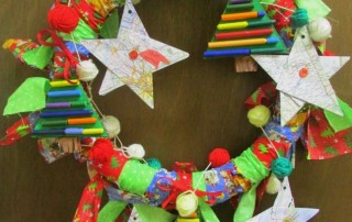 Collaborative holiday wreath made by students from recycled materials