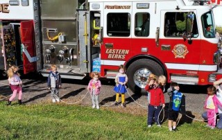 Brookeside Montessori School students by fire trucks