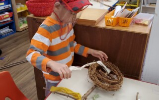 Student creating a scarecrow