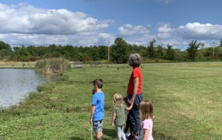 A Walk to the Pond - Students and Teacher Stand on the Shore