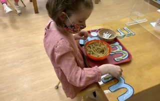 Brookeside Montessori School Primary Student Making a Craft